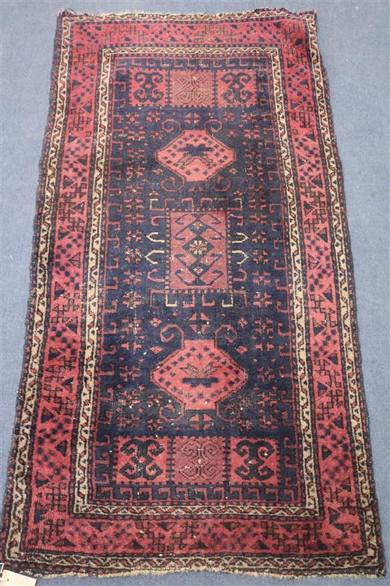 A red and blue ground rug, 155 x 78cm